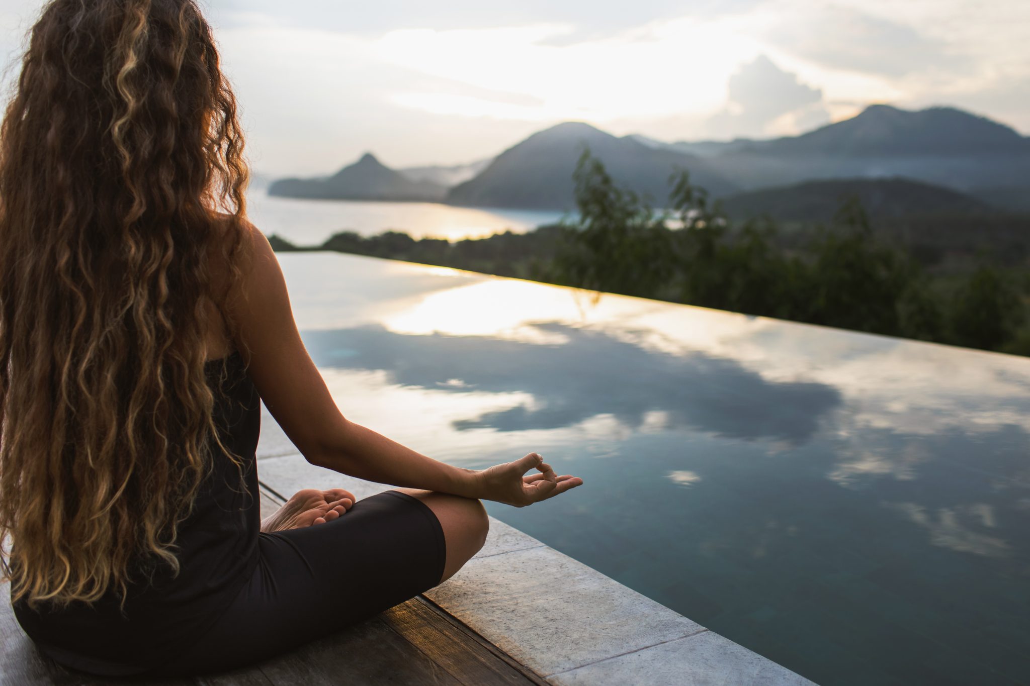 Woman,Meditating,And,Practicing,Yoga,Alone,At,Sunrise,Near,Infinity